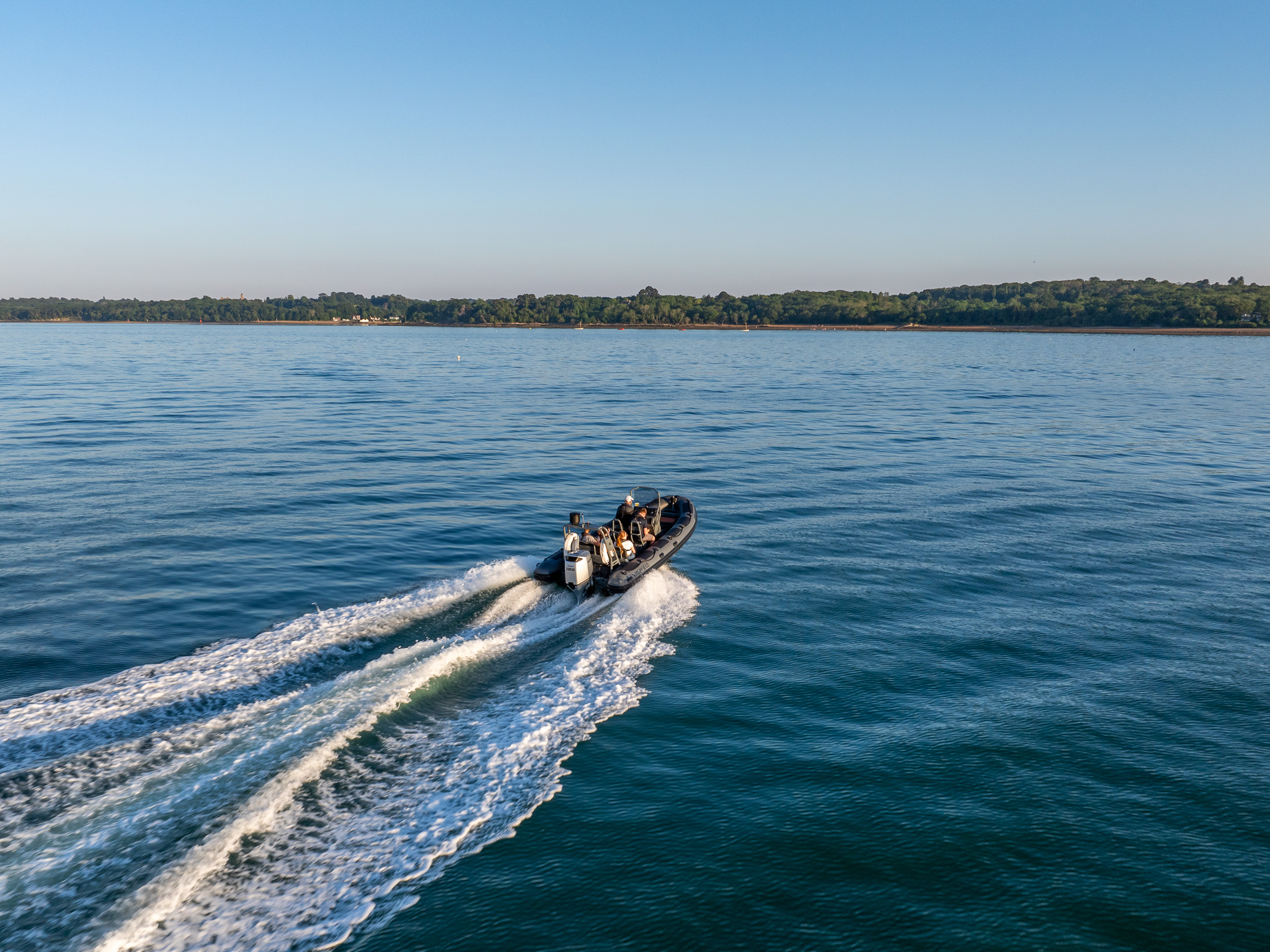 Aerial view of a RIB boat cruising along the Hampshire coast